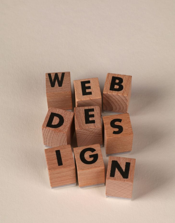 Wooden blocks arranged to spell 'Web Design'. Perfect for creative, digital content themes.